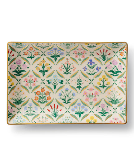 The Estee Catchall Tray is a porcelain dish with a vibrant repeating floral pattern and green leaves on a cream background, finished with a gold rim—ideal for adding charm as a decorative or catchall tray.