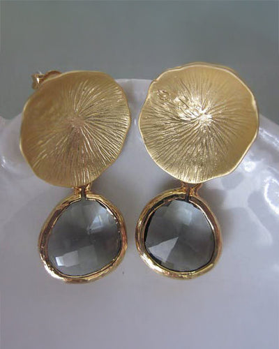 The Charcoal Gray Earrings - Gold feature textured round gold discs above faceted oval charcoal gems, making them a stylish gift, beautifully presented in a gift box.