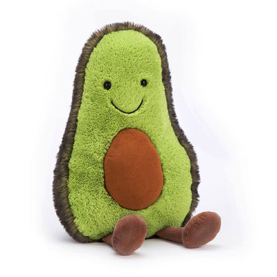 A cheerful Jellycat Amuseables Avocado plush toy with a bright green interior, a stitched smile, a fluffy dark green exterior, a plush brown pit, and dangling cordur