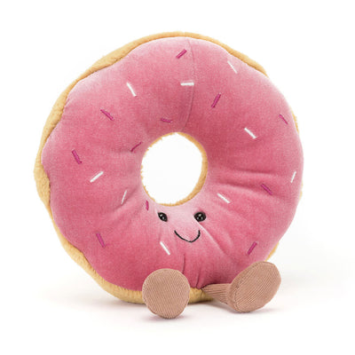 Front-facing view of Jellycat Amuseables Doughnut plush: A pink frosted doughnut plush with colorful sprinkle details, smiling face, and dangling brown corduroy legs, giving it a playful personality.