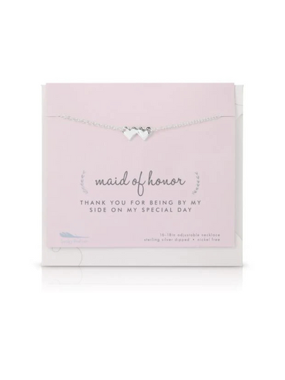 The Best Day Ever Necklace - Maid Of Honor is a silver heart pendant from our bridal collection. It comes on a pink card saying, "maid of honor. Thank you for being by my side on my special day," and is packaged in a white envelope, perfect for gifting.