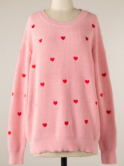 Pink Heart Confetti Valentine's Day sweater with red heart designs, featuring a relaxed fit and soft viscose-polyester-nylon blend. View from the front as displayed on a mannequin.