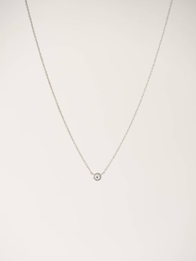 Silver solitaire necklace featuring a petite Swarovski crystal pendant on a delicate chain, displayed against a light neutral background.