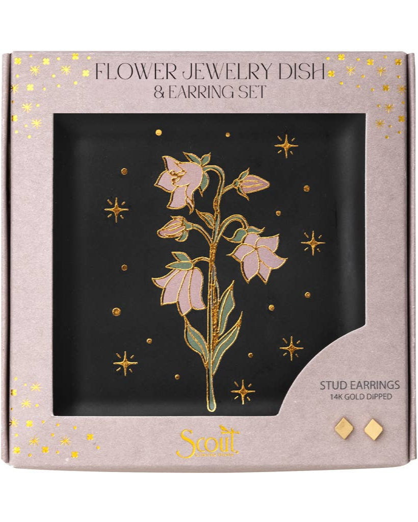 The Jewelry Dish & Stud Earring Set - Flower/Black features a ceramic dish with a gold and pink floral design, gold stars, and 14k gold-plated floral stud earrings, beautifully presented in a pink box for an elegant touch.