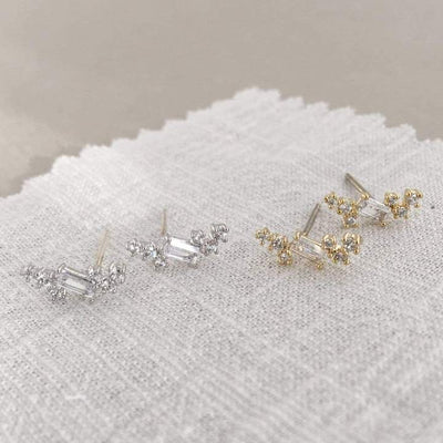 Swarovski Crystal Climber Earrings in gold and silver resembling delicate laurel leaves, adorned with cubic zirconia stones on sterling silver posts.